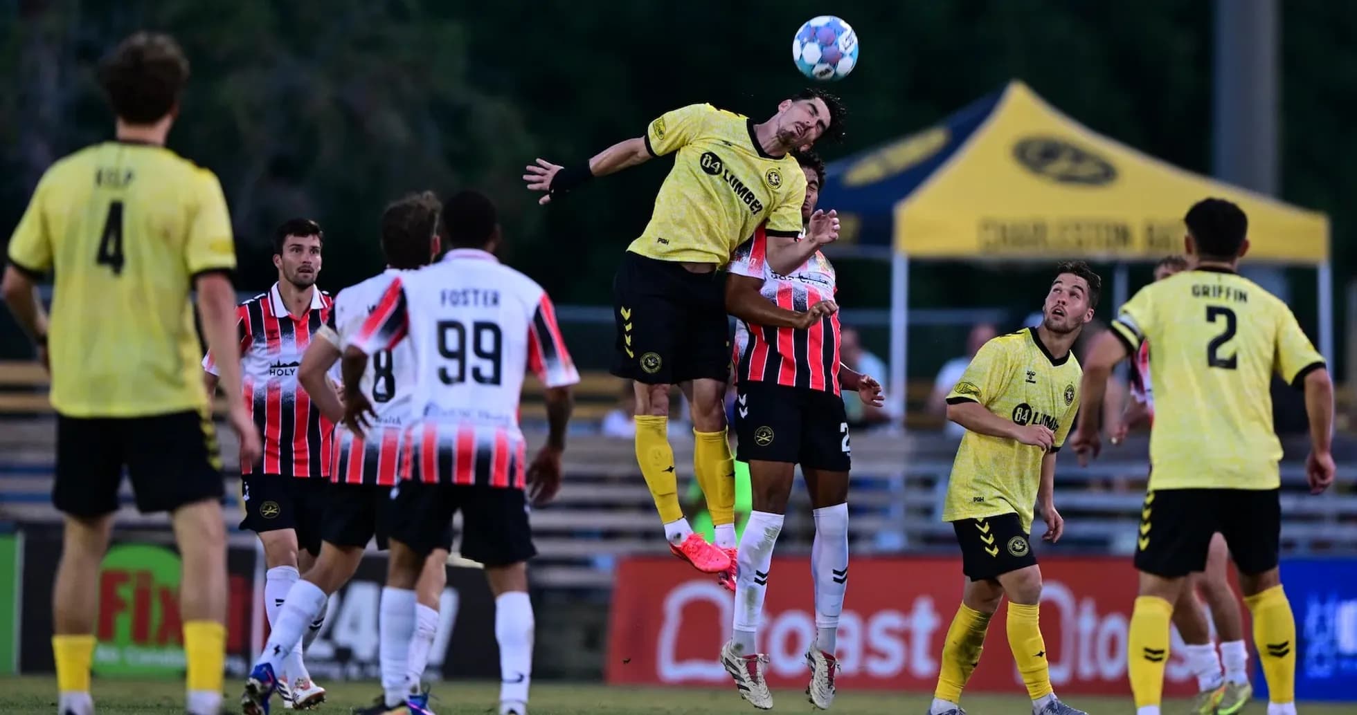 Players competing for the ball during Charleston Battery match