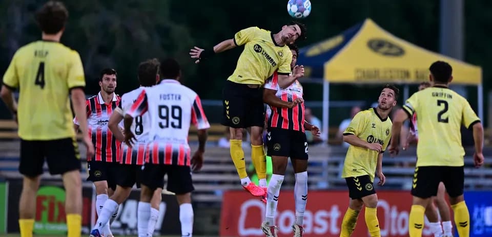 Players competing for the ball during Charleston Battery match
