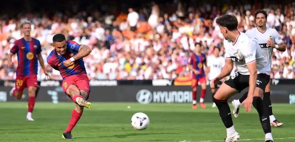Player striking ball during match between Barcelona and Valencia