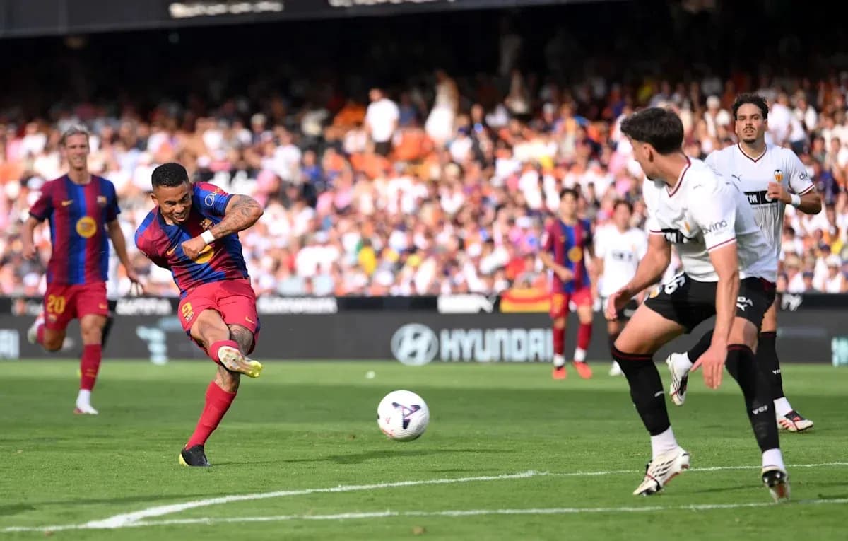 Player striking ball during match between Barcelona and Valencia