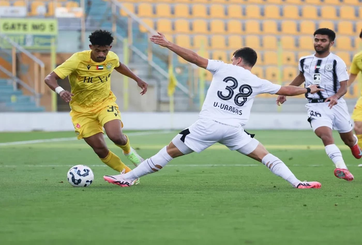 Player dribbling during Al Wasl vs Al Jazira match