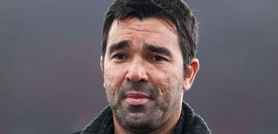 Man with short dark hair and a scarf