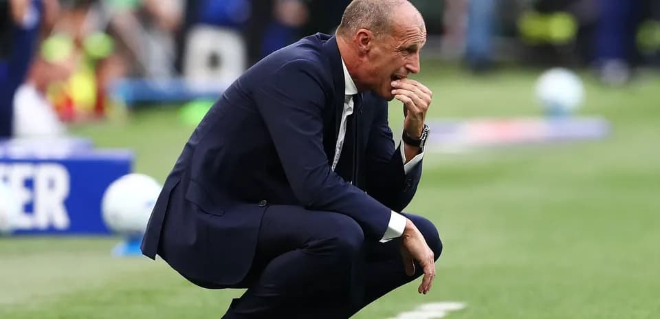 Coach kneeling on the sideline during match