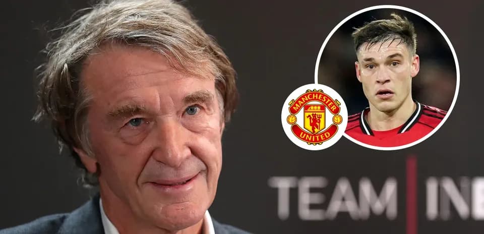 Man speaking at press conference with Manchester United logo