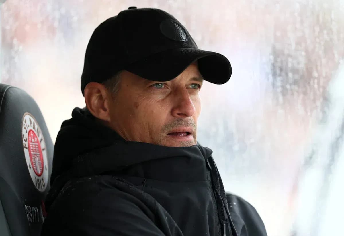 Coach sitting on bench during rainy match