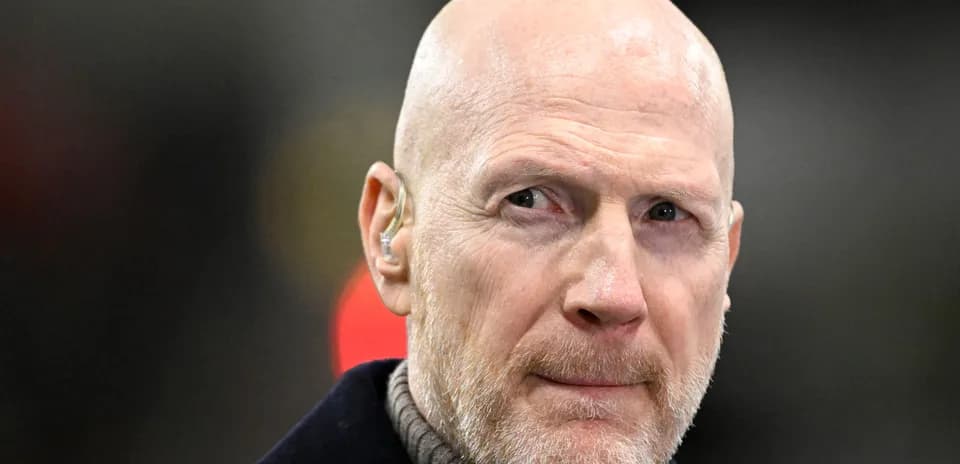 Bald man with a beard wearing an earpiece