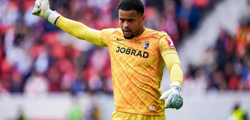 Goalkeeper signaling during a match in yellow kit