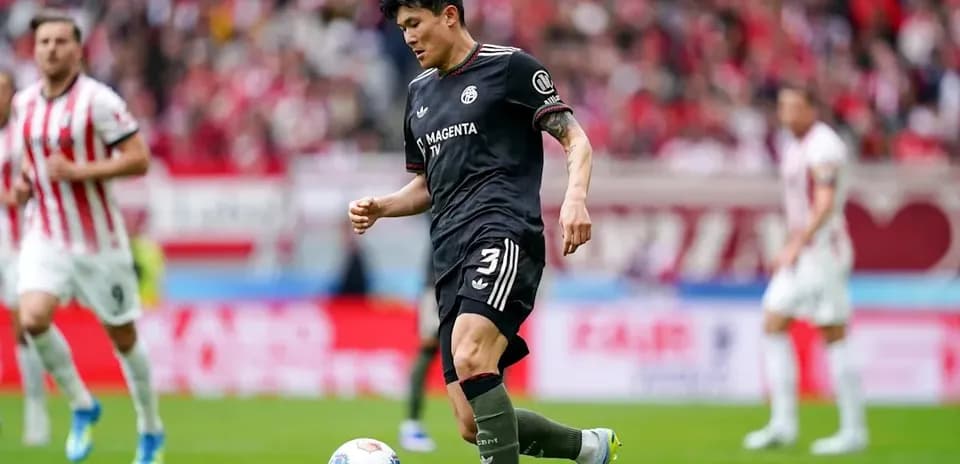 Player in black kit preparing to kick ball