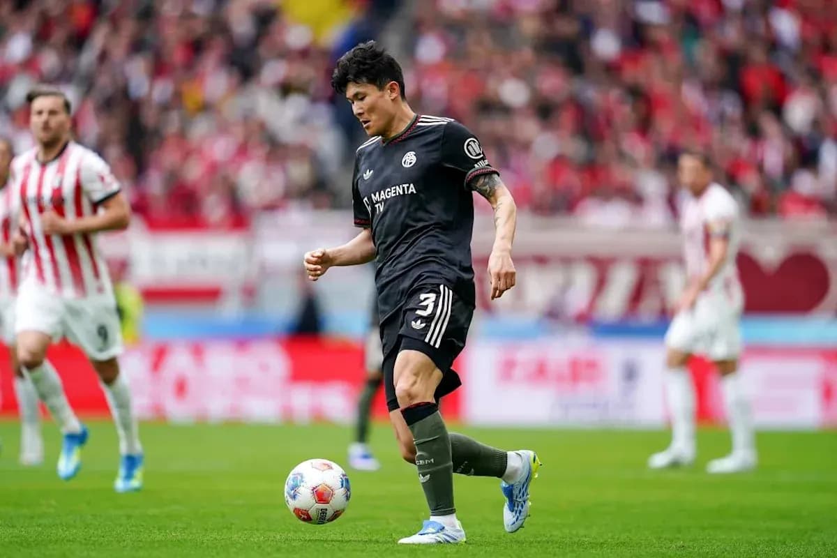 Player in black kit preparing to kick ball