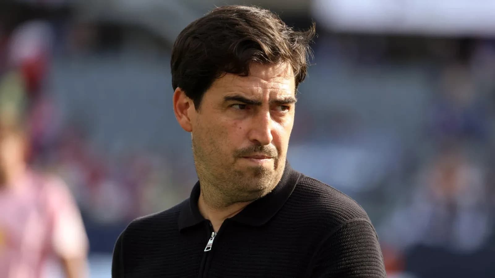 Coach observing the match from the sidelines