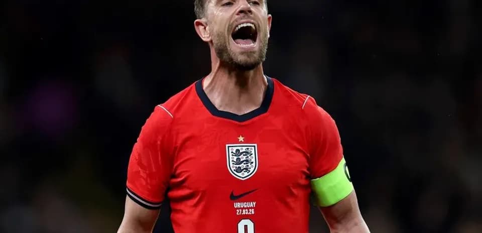 Player celebrating in England jersey with captain's armband