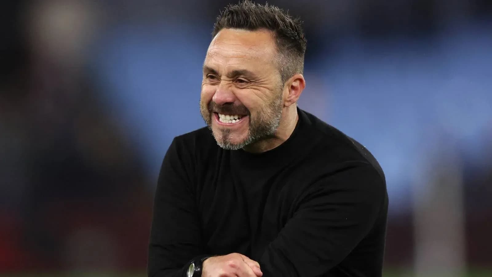 Coach celebrating on the sidelines during match