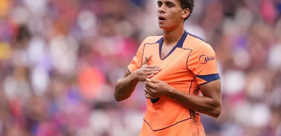 Player in orange jersey during match warm-up