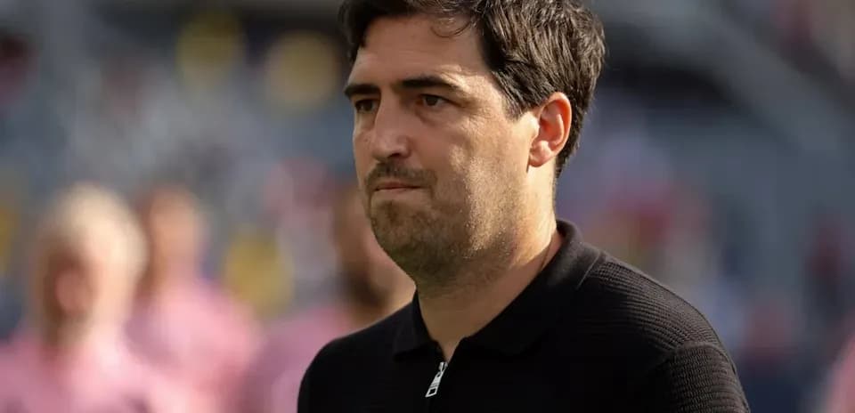 Coach observing players during a match warm-up