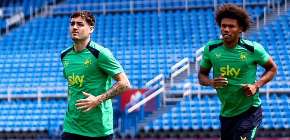 Two players jogging on the training pitch