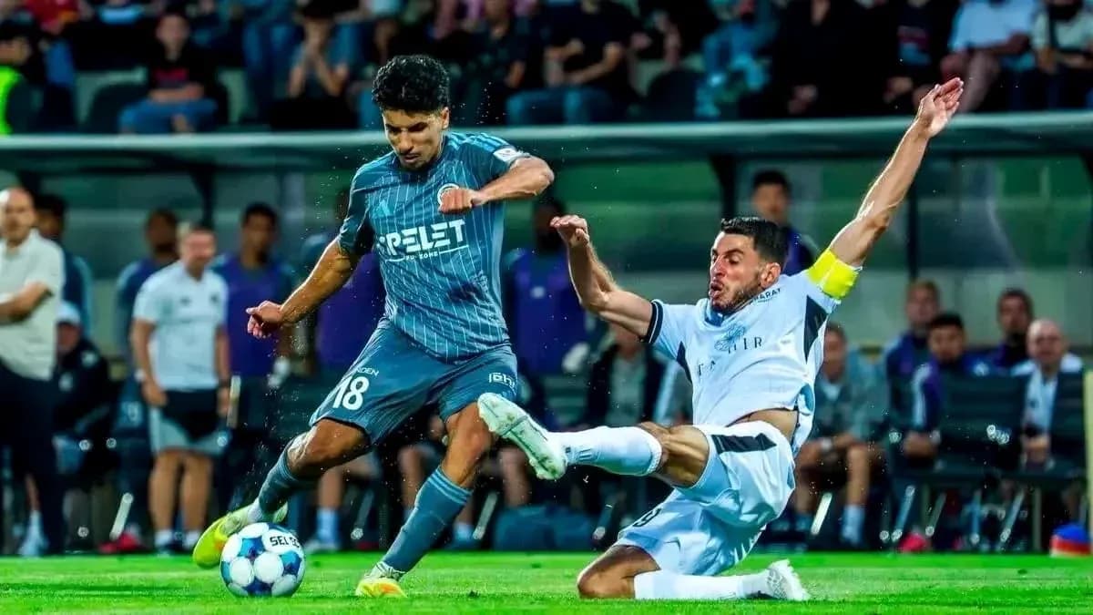Player tackles opponent during UEFA Champions League match