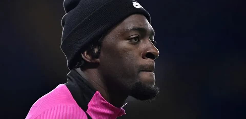 Player in pink training top and black beanie