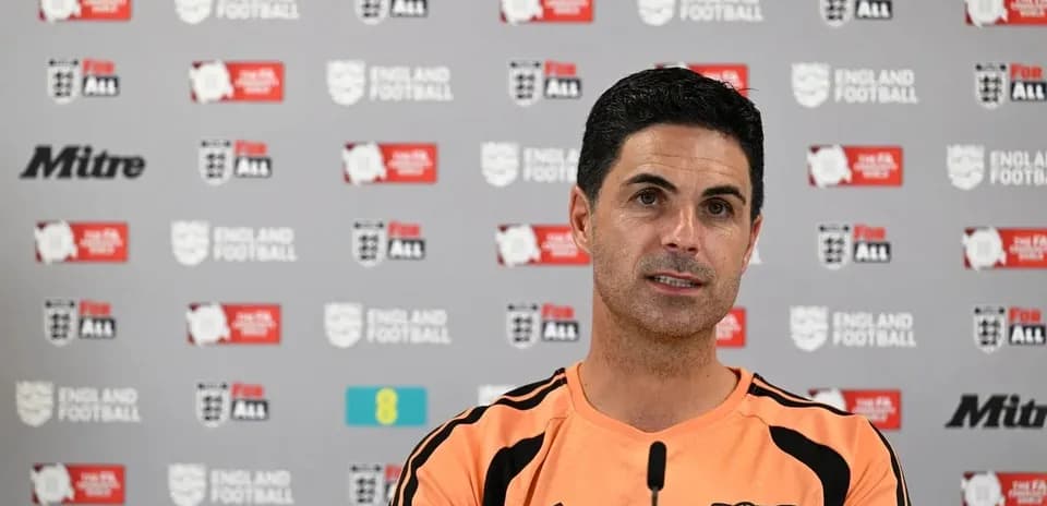 Manager speaking at press conference with branding backdrop