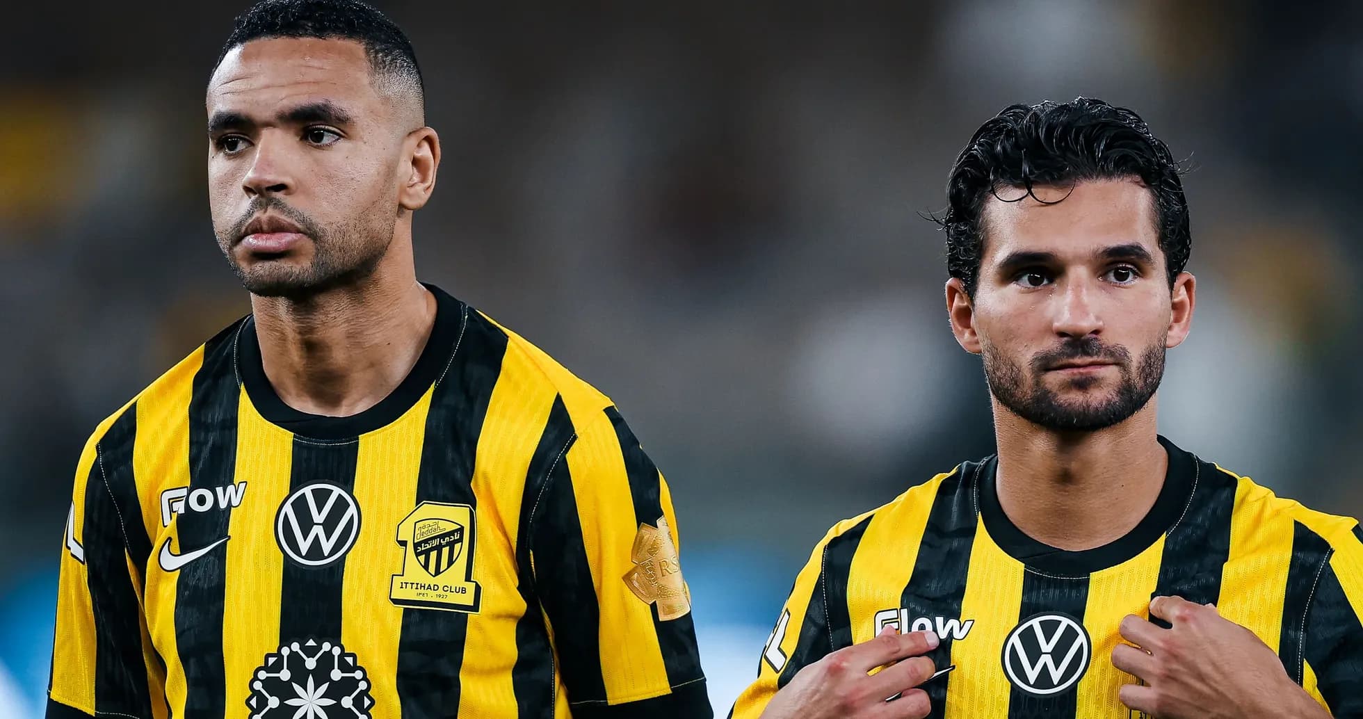 Two players in yellow and black jerseys on field
