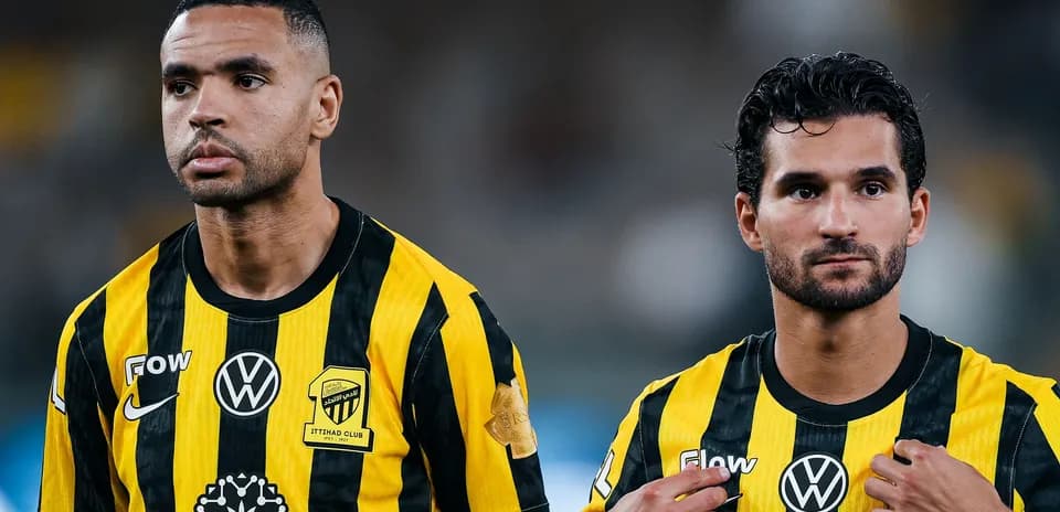 Two players in yellow and black jerseys on field