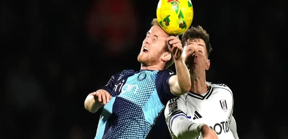 Two players contesting for the ball during match