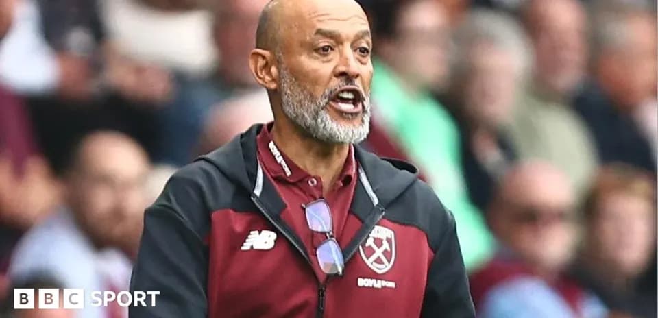 Manager gesturing during a match on the sideline