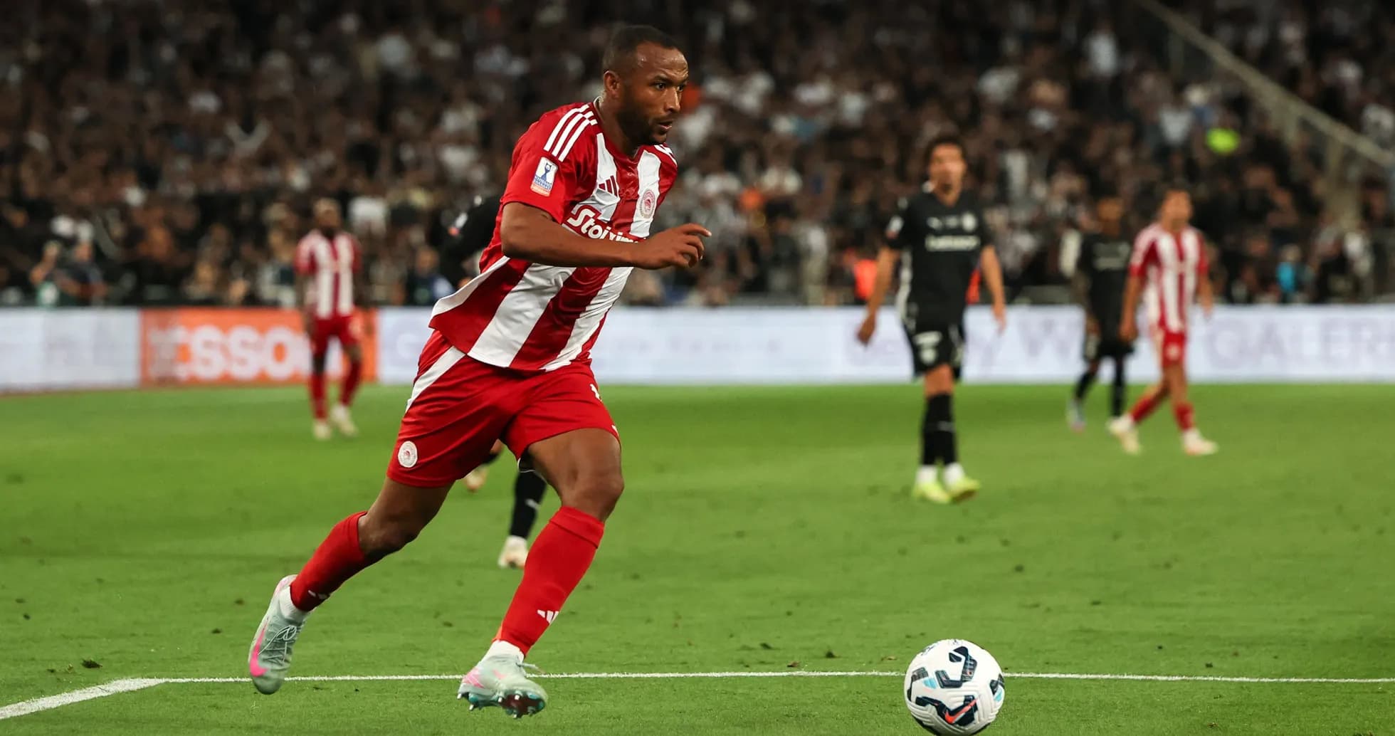 Player in red and white sprinting on the field