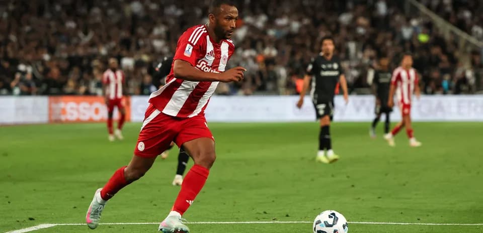 Player in red and white sprinting on the field