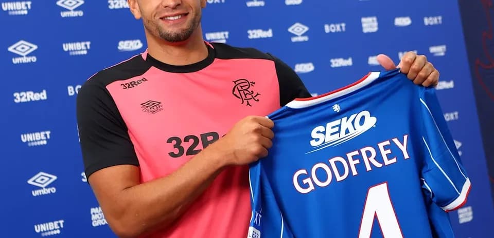 Player holding Rangers FC jersey with Godfrey number 4