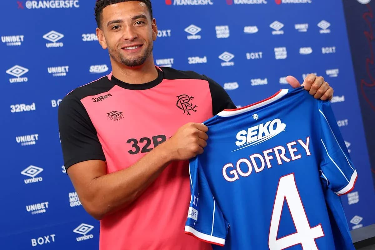 Player holding Rangers FC jersey with Godfrey number 4
