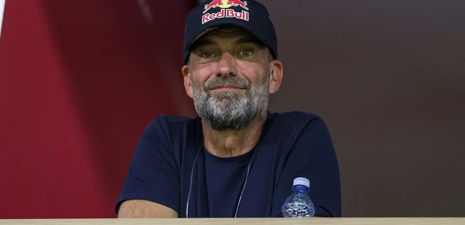 Man with beard wearing a Red Bull cap