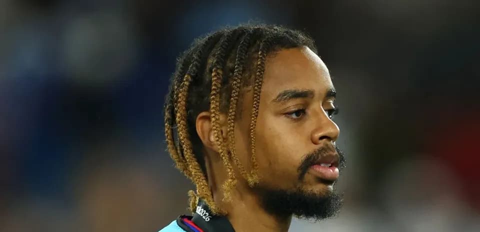 Player with braided hair wearing a light blue jersey