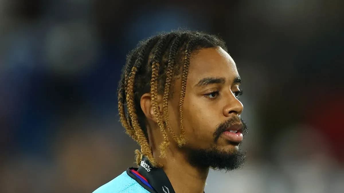 Player with braided hair wearing a light blue jersey
