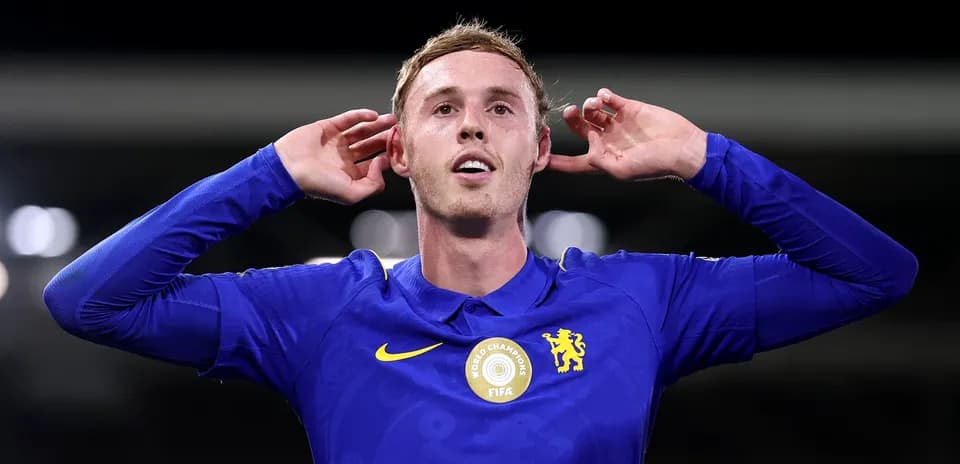 Player celebrating with hands to ears after scoring