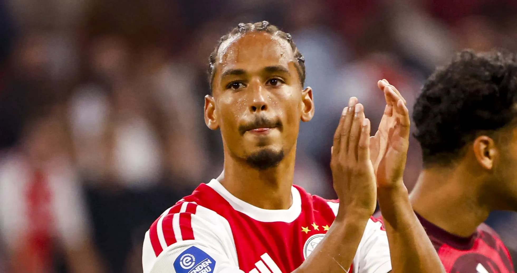 Player applauding fans after a match