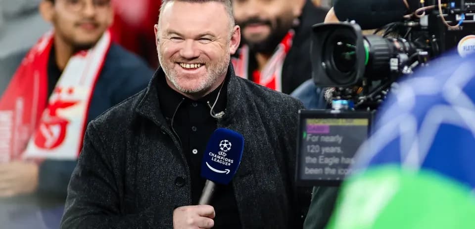 Presenter smiling with microphone at Champions League event