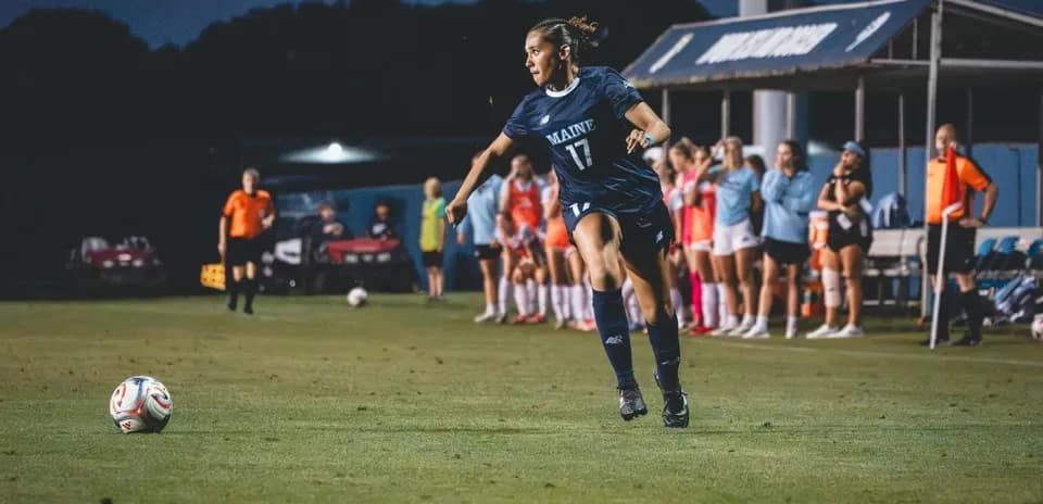 Player from Maine kicking ball during soccer match