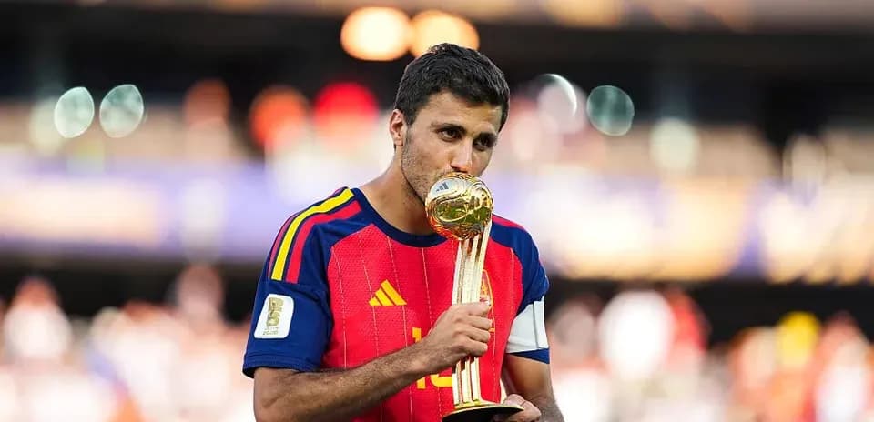 Player kissing FIFA World Cup trophy on field
