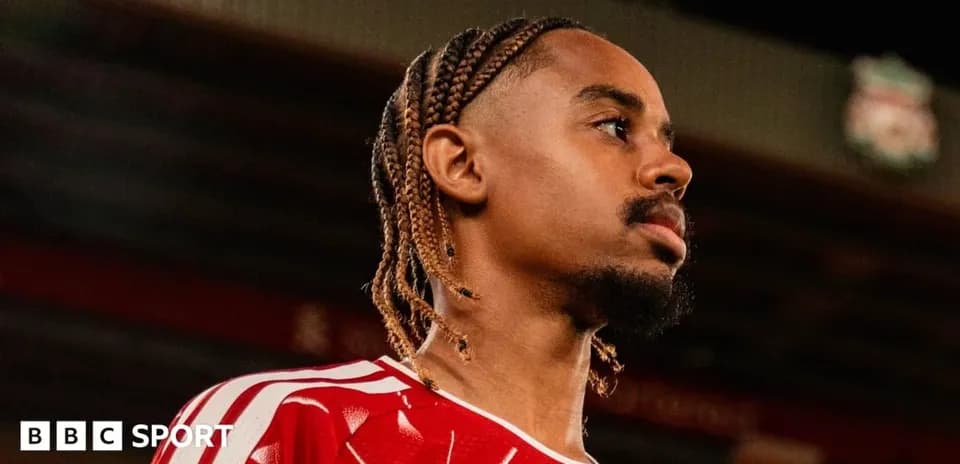 Player in red jersey looking away from camera