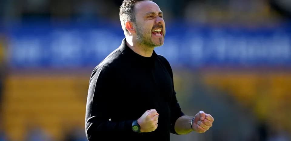 Manager celebrating during a match on the sidelines