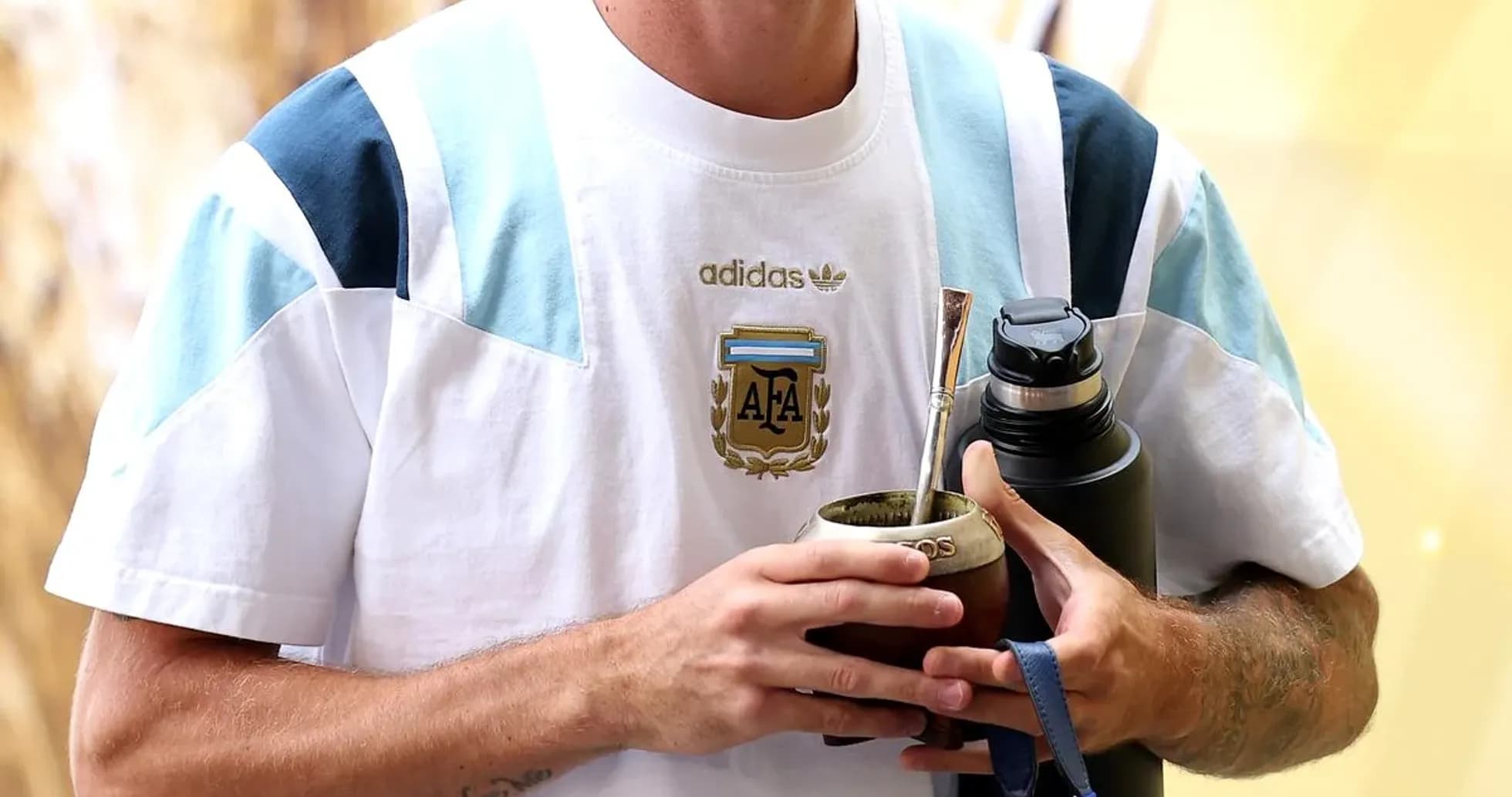 Player holding mate and water bottle, wearing Argentina jersey