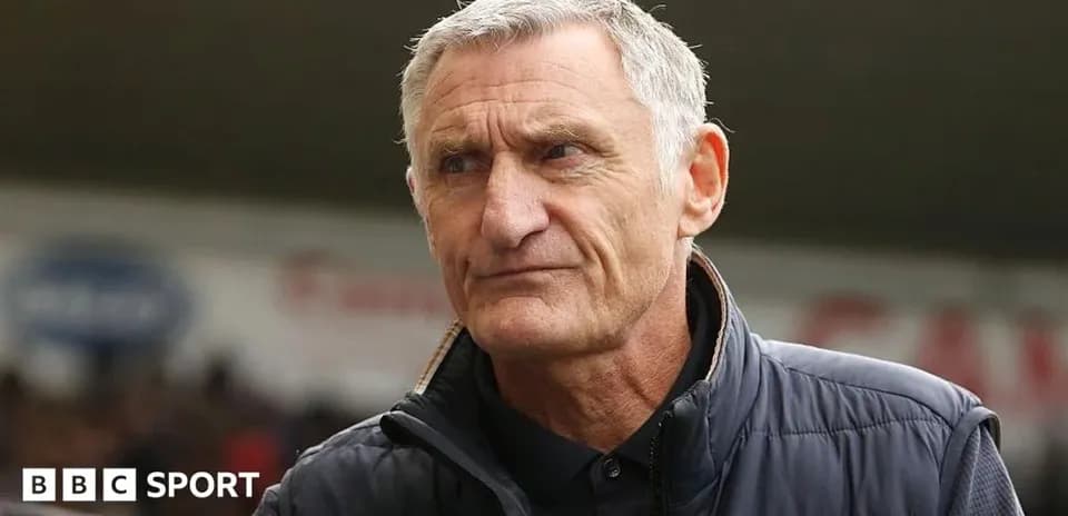 Manager standing on the sidelines during a match