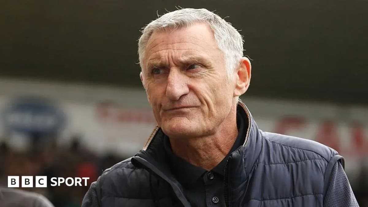 Manager standing on the sidelines during a match