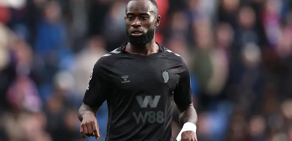 Player in black kit on the pitch during match