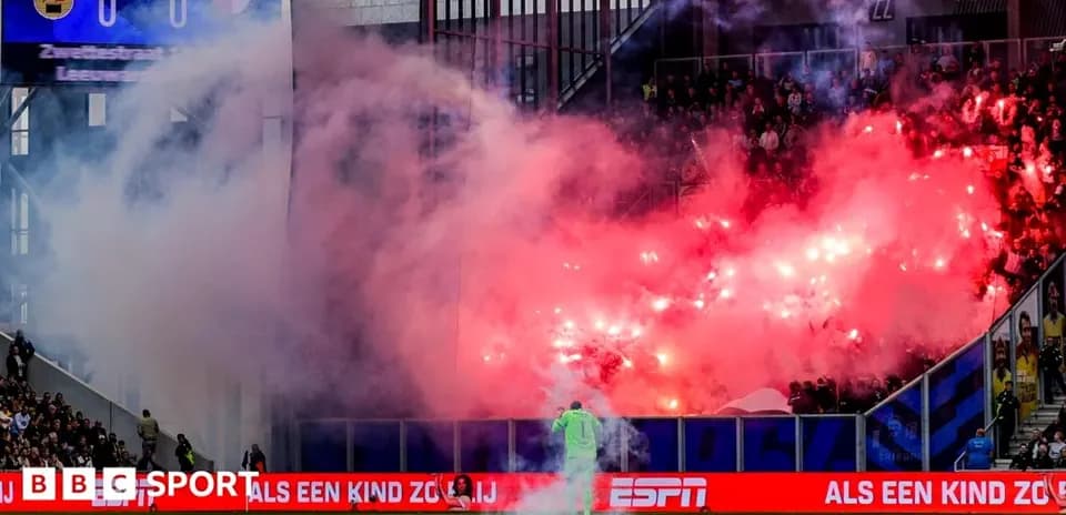 Fans celebrating with flares during football match