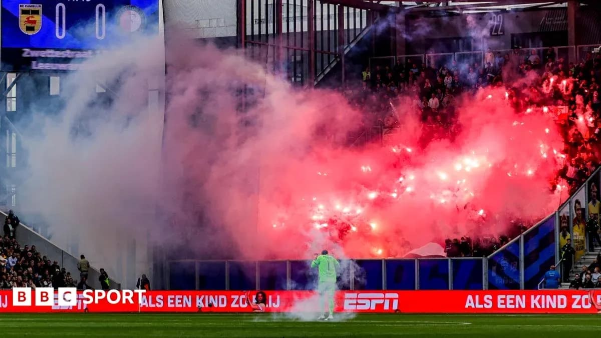 Fans celebrating with flares during football match