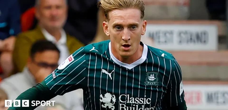 Player in green kit running during a match