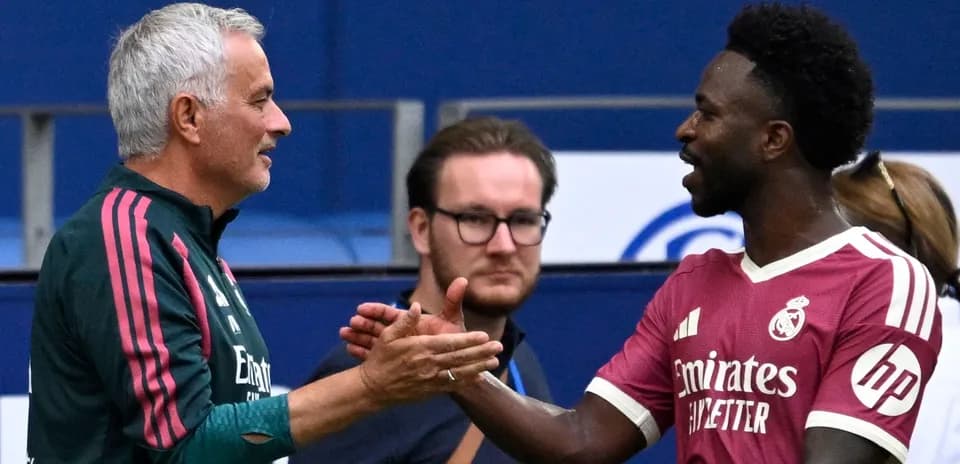 Coach and player shaking hands on the field
