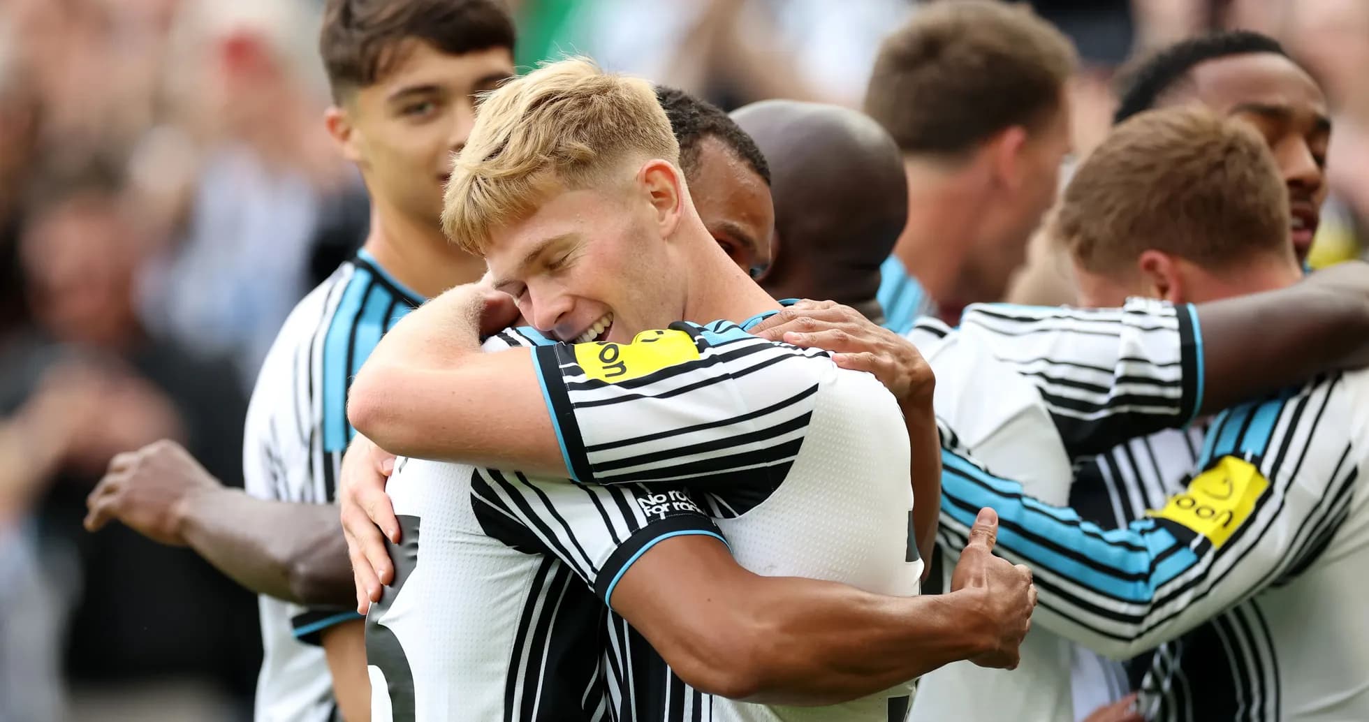 Players celebrating with hugs after scoring a goal