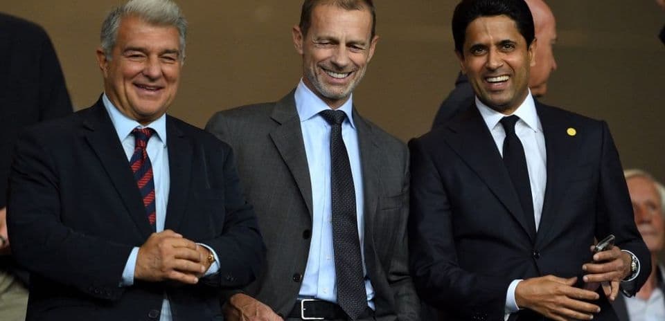 Three men smiling at an event or match
